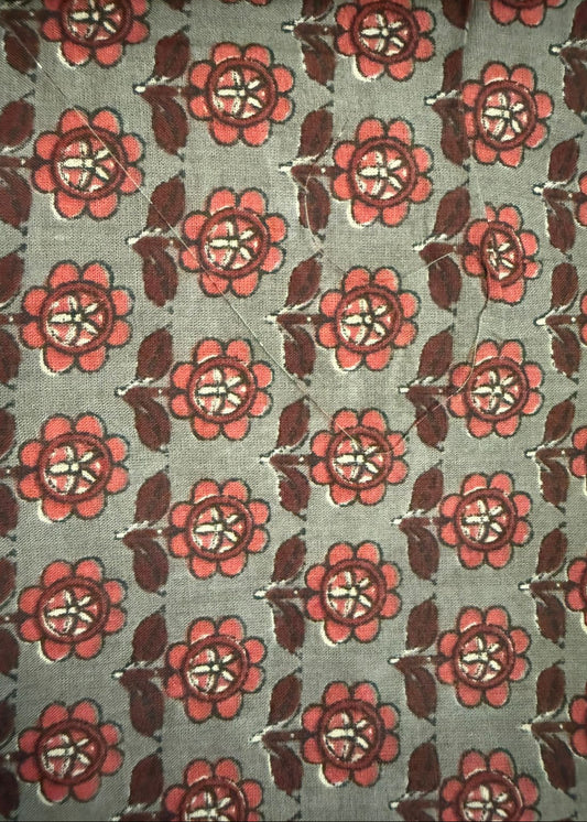 Patterned fabric with red flowers on a green background