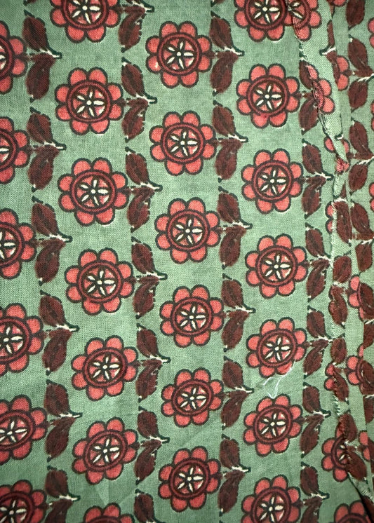 Patterned fabric with red flowers and green background